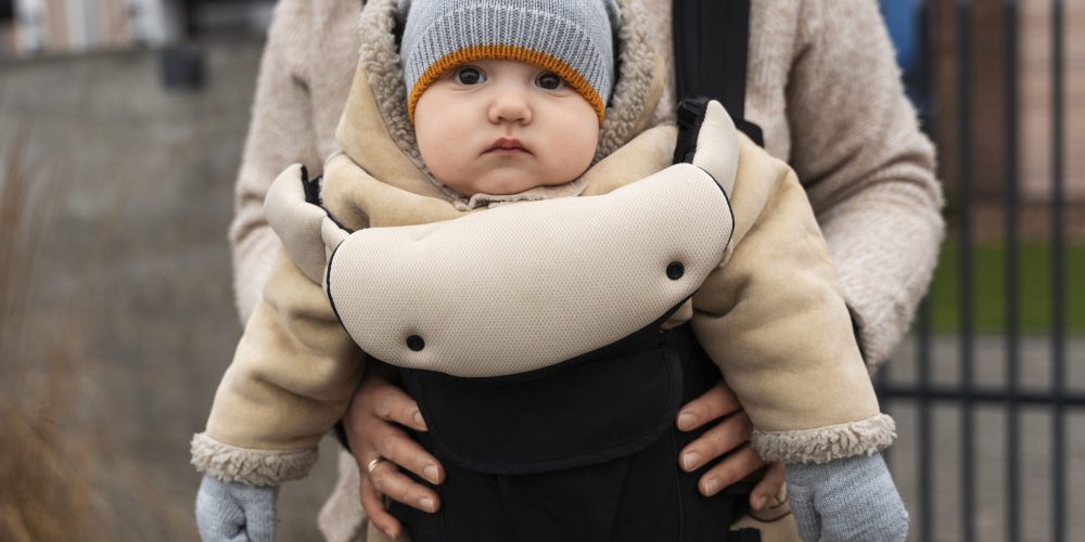 front-view-woman-holding-baby-carrier